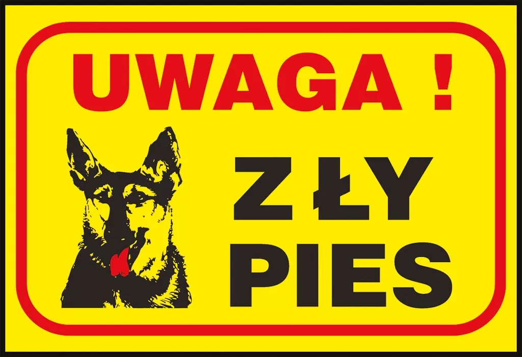 Znak bezpieczeństwa o prostokątnym kształcie, z żółtym tłem i czerwoną ramką. Na znaku znajduje się czarno-białe zdjęcie psa i napis w czarnych literach: „UWAGA! ZŁY PIES”.