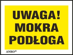 Żółta naklejka z czarnym napisem „UWAGA! MOKRA PODŁOGA” w ramce.