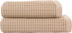 Beżowy ręcznik o wymiarach 50x90 cm wykonany z bawełny egipskiej, o strukturze waflowej. Produkt oznaczony jako Ręcznik NATURAL.